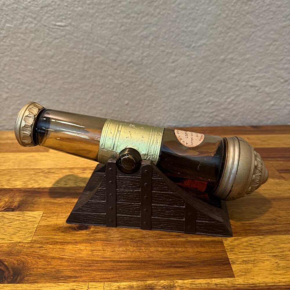 Vintage Avon Cannon Shaped Amber Glass Decanter with Stand 1966 Collectible
